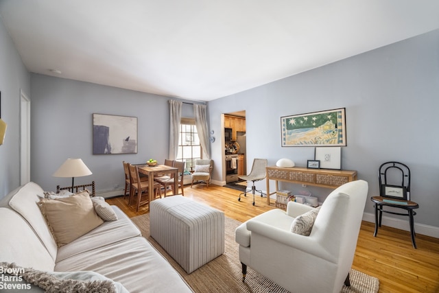 living area featuring baseboards and wood finished floors