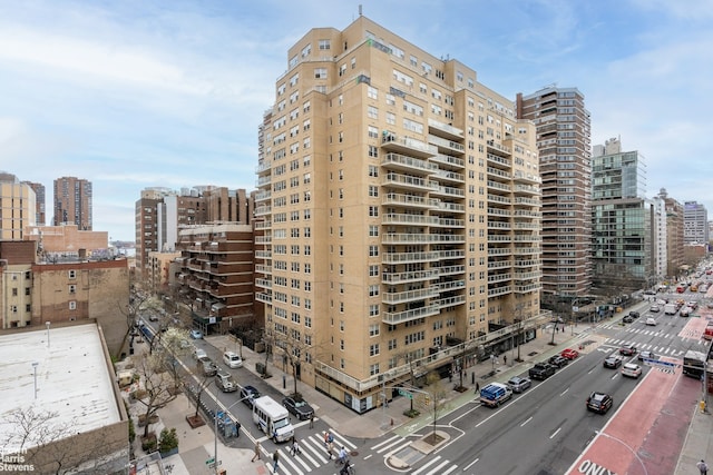 view of property with ac unit and a view of city