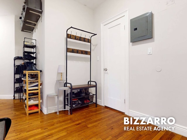 interior space featuring hardwood / wood-style floors, electric panel, and baseboards