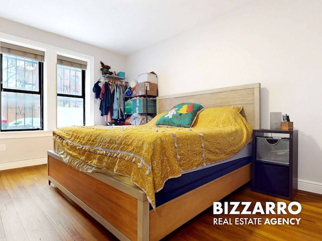 bedroom with wood finished floors and baseboards