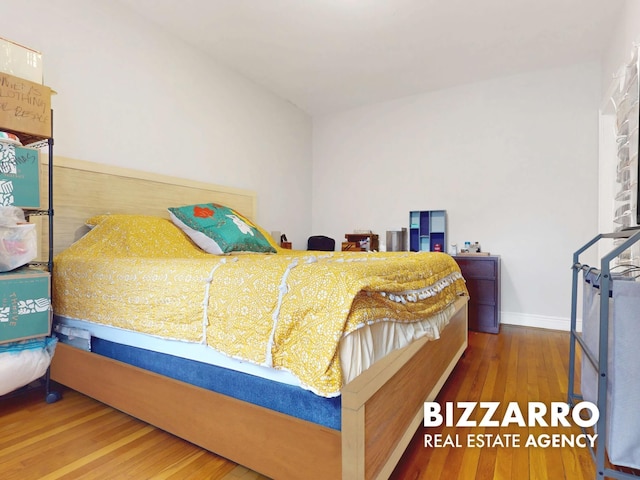 bedroom with baseboards and hardwood / wood-style floors