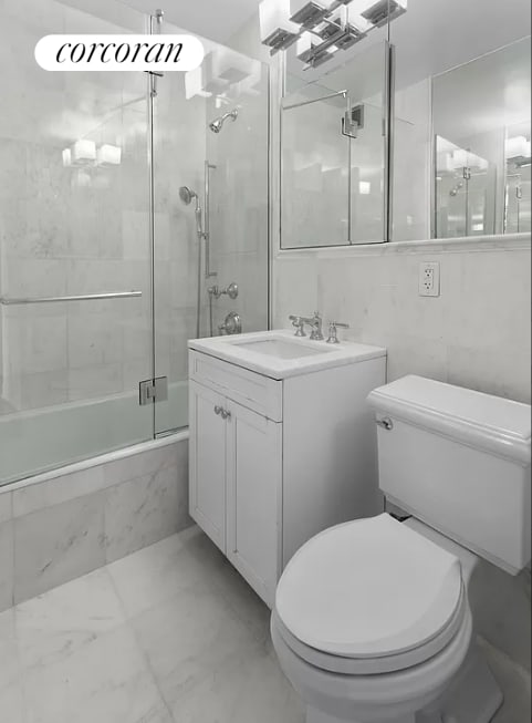 201 E 25th St Unit 19D, New York City, NY 10010 - full bath featuring tiled shower / bath combo, toilet, marble look tile flooring, and vanity