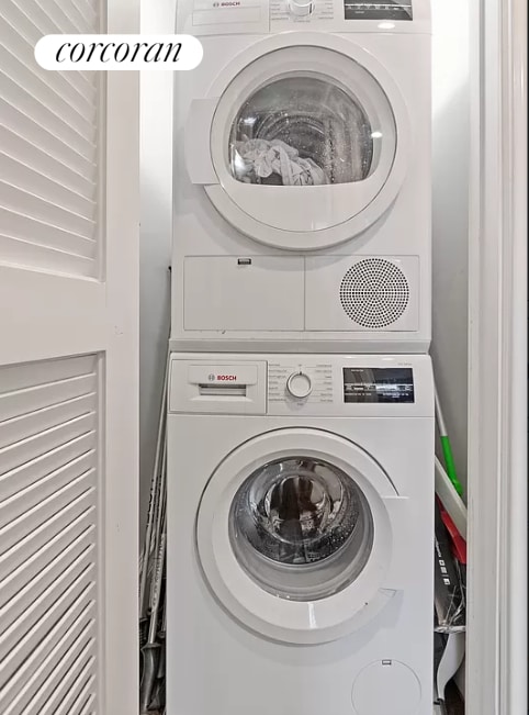 laundry room with stacked washing maching and dryer and laundry area