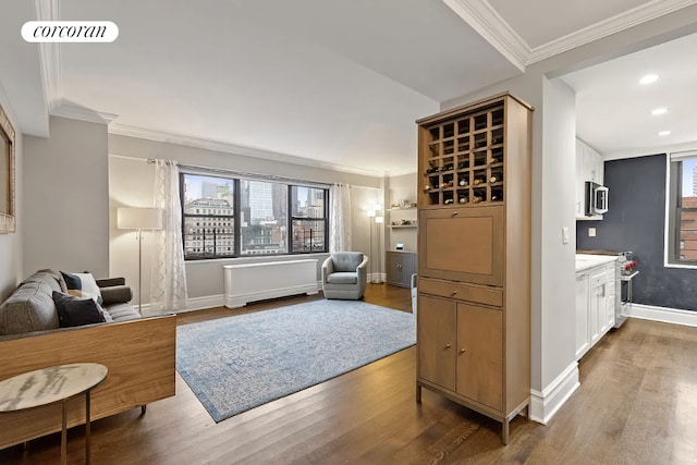living room with ornamental molding, a healthy amount of sunlight, and wood finished floors