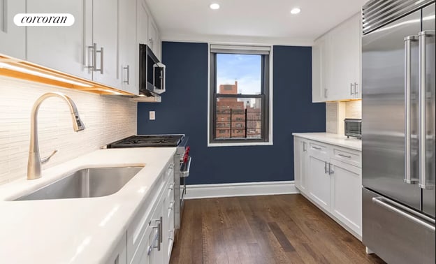 kitchen featuring white cabinets, a sink, light countertops, recessed lighting, and high end appliances