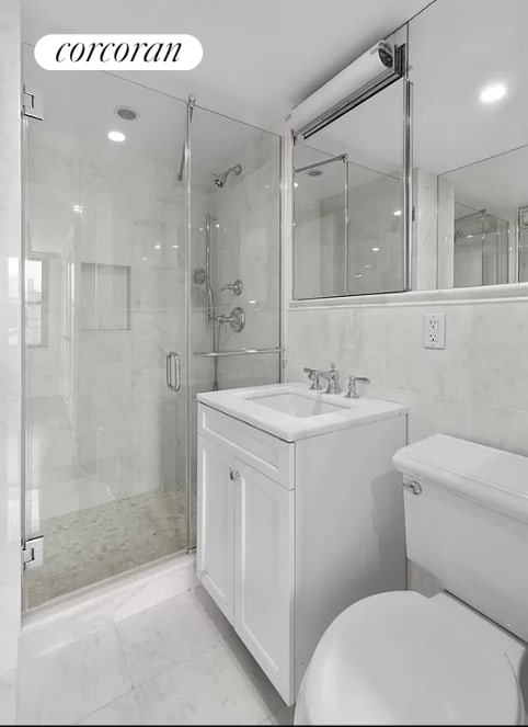 bathroom with vanity, recessed lighting, a stall shower, and toilet