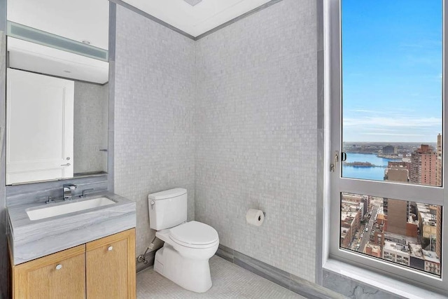 bathroom featuring toilet, tile patterned floors, and vanity