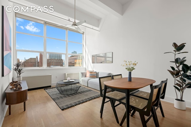 dining room featuring a ceiling fan, wood finished floors, and baseboards