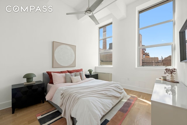 bedroom with light wood-type flooring and baseboards