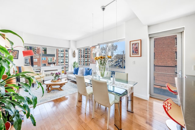 dining area featuring light wood-style floors and baseboards