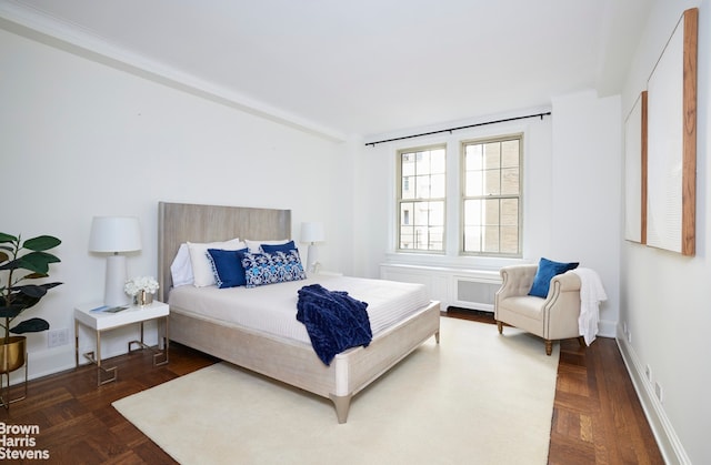 bedroom featuring baseboards and radiator