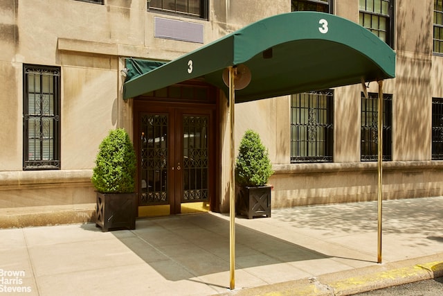 view of exterior entry featuring french doors