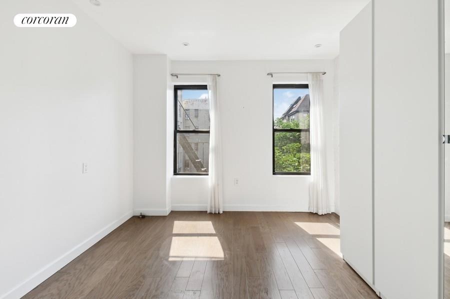 unfurnished room featuring wood finished floors and baseboards