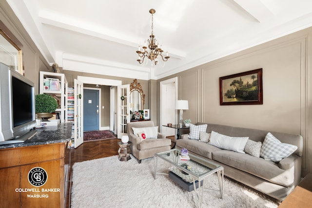 living room with a chandelier and a decorative wall
