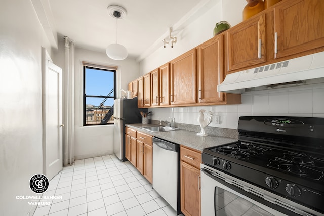kitchen featuring stainless steel appliances, under cabinet range hood, backsplash, brown cabinetry, and light tile patterned floors