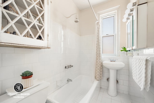 full bathroom with tile walls, shower / bath combo, tile patterned flooring, and toilet