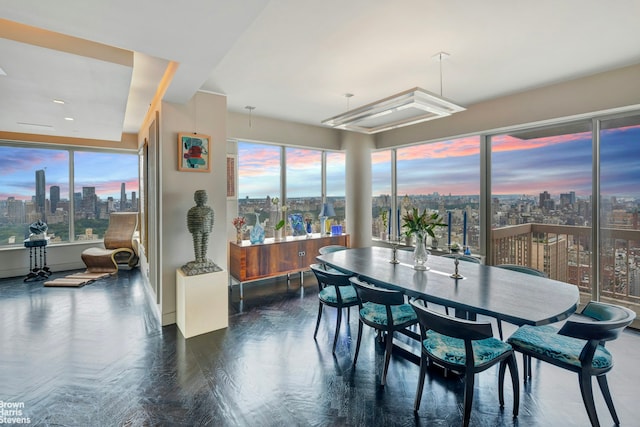 200 E 69th St Unit 42A, New York City, NY 10021 - dining room with a view of skyline, wood finished floors, and baseboards