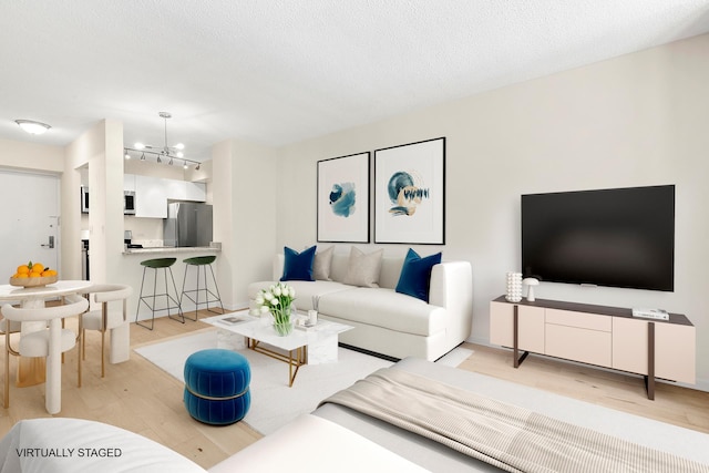 living area with an inviting chandelier and light wood finished floors