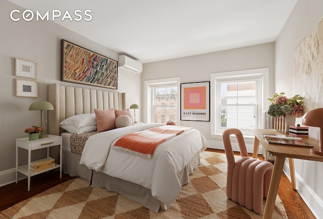 130 Fort Greene Place, New York City, NY 11217 - bedroom with an AC wall unit, wood finished floors, and baseboards