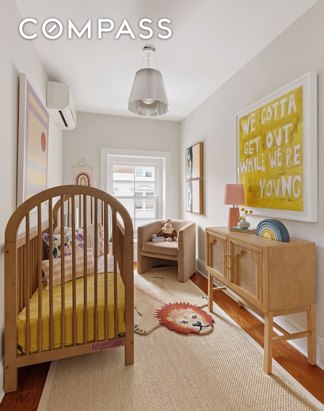 130 Fort Greene Place, New York City, NY 11217 - bedroom featuring a wall mounted AC, wood finished floors, and baseboards