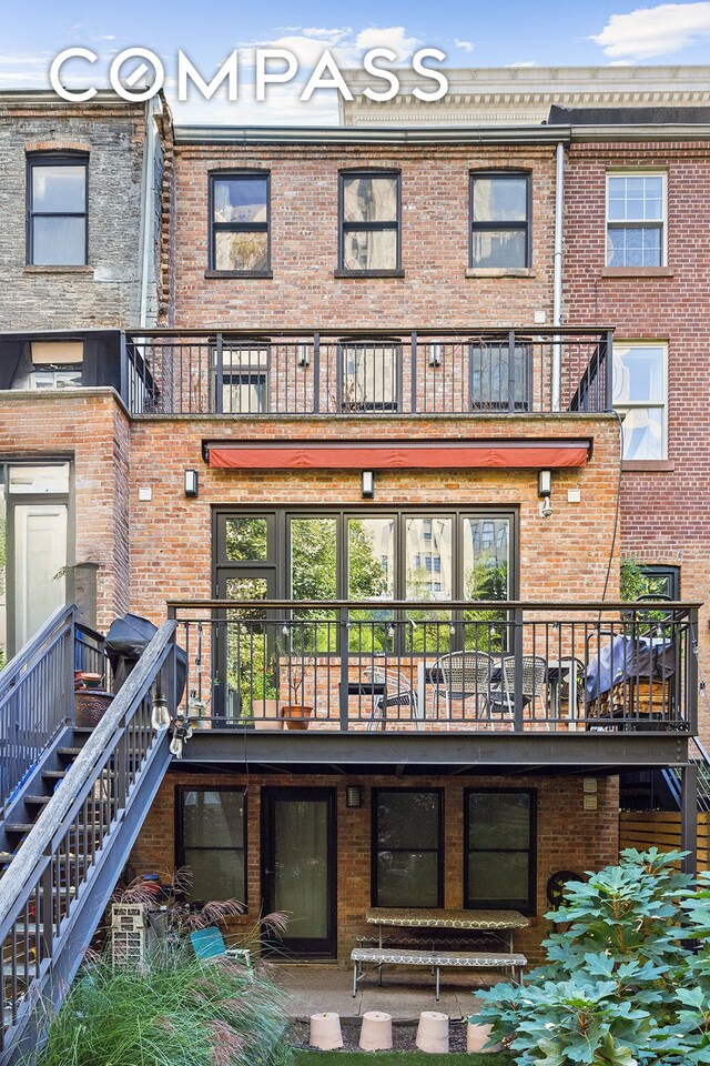130 Fort Greene Place, New York City, NY 11217 - rear view of house featuring a balcony, brick siding, and stairs