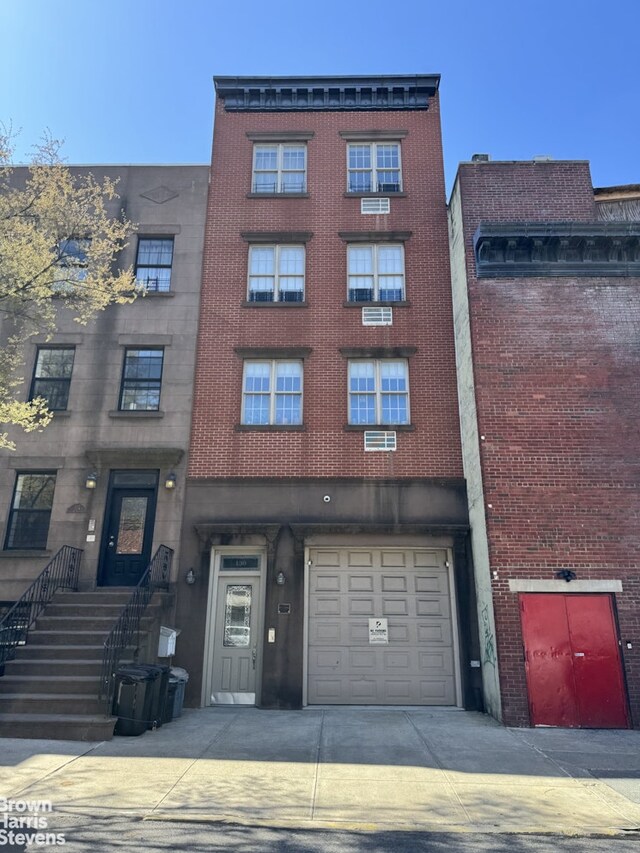 130 Degraw St, New York City, NY 11231 - view of building exterior with a garage and concrete driveway