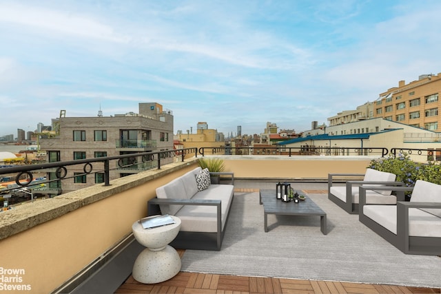 view of patio featuring an outdoor living space, a city view, and a balcony