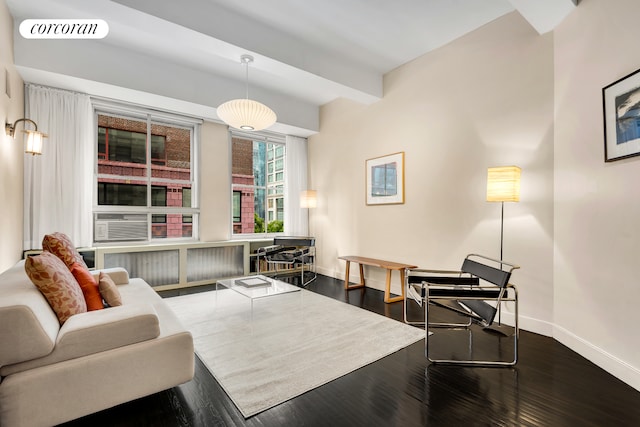 living area with baseboards and dark wood-style flooring