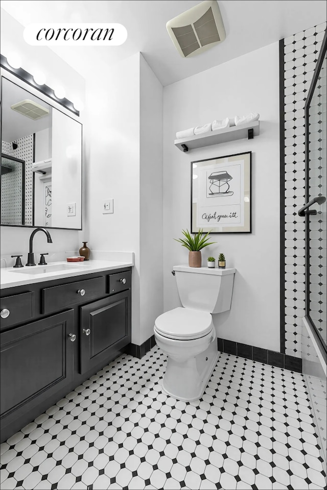 425 Park Ave S Unit 2C, New York City, NY 10016 - bathroom featuring toilet, vanity, a shower with door, and baseboards