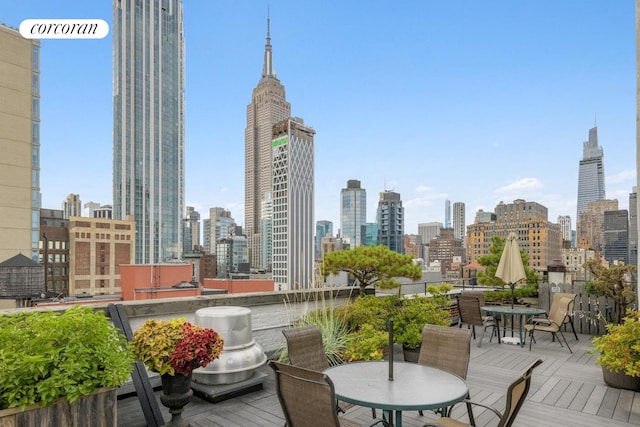 deck featuring a skyline view and outdoor dining area