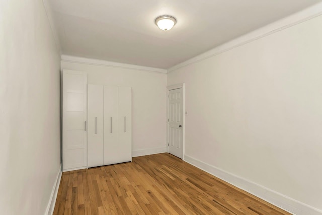 561 41st St Unit 2C, New York City, NY 11232 - unfurnished bedroom featuring crown molding, light wood-type flooring, and baseboards