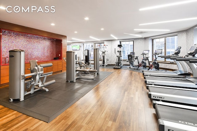 75 Wall St Unit 36F, New York City, NY 10005 - gym featuring wood finished floors and recessed lighting