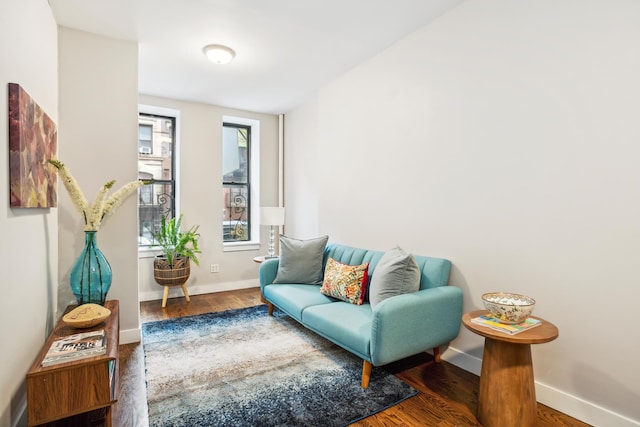 sitting room featuring baseboards and wood finished floors