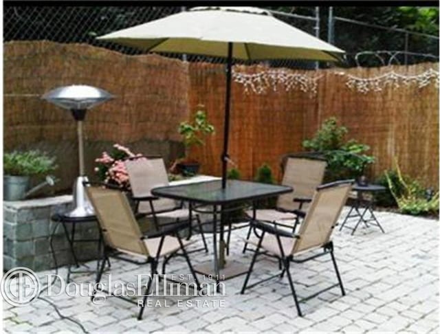 view of patio / terrace featuring fence and outdoor dining space