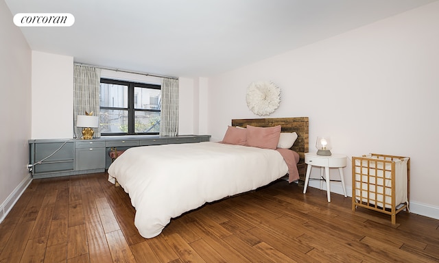 bedroom featuring baseboards, dark wood finished floors, and visible vents