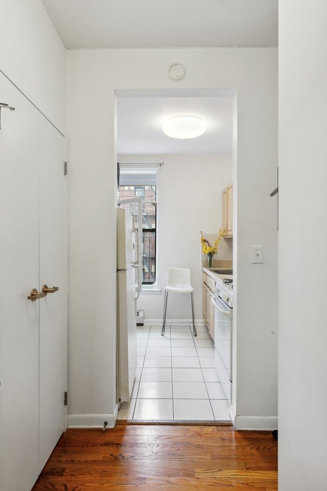 167 W 129th St Unit 4D, New York City, NY 10027 - corridor featuring light wood finished floors and baseboards
