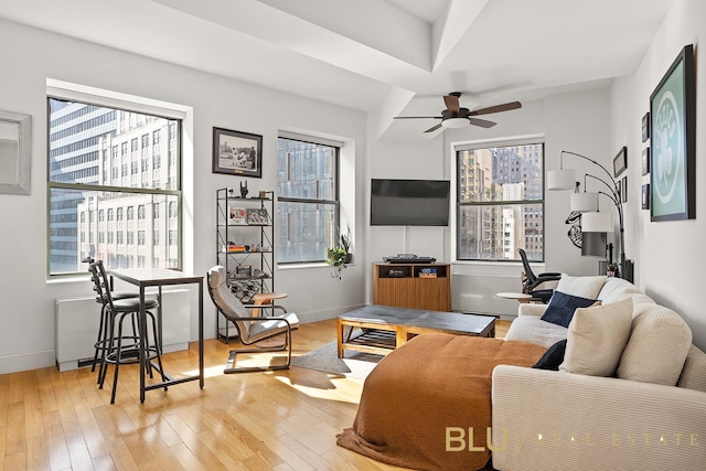 99 John St Unit 2006, New York City, NY 10038 - living area with light wood finished floors, a ceiling fan, and plenty of natural light