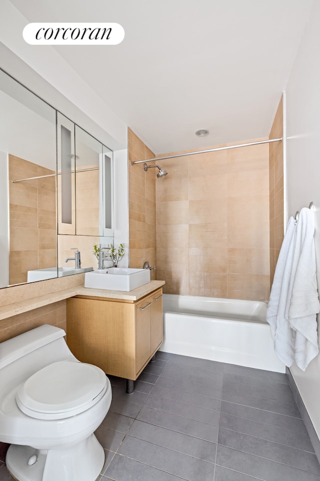bathroom featuring vanity, shower / bathing tub combination, tile patterned floors, and toilet