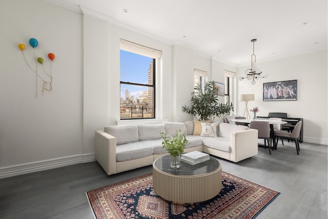 living room featuring a chandelier, wood finished floors, baseboards, and ornamental molding