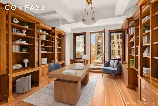 home office featuring beamed ceiling and light wood-style floors