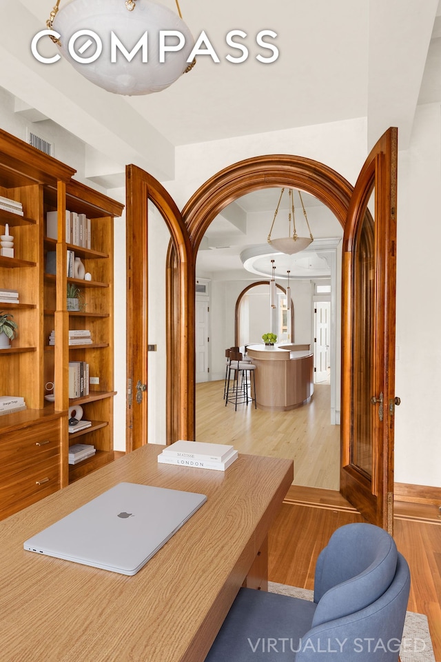 252 W 30th St Unit 12, New York City, NY 10001 - office area with arched walkways and light wood-style flooring