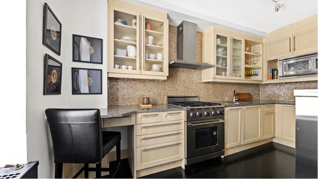 333 W 56th St Unit 8I, New York City, NY 10019 - kitchen featuring appliances with stainless steel finishes, wall chimney exhaust hood, a sink, dark wood finished floors, and light stone countertops