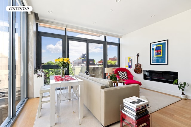 508 Waverly Ave Unit 4, New York City, NY 11238 - living area featuring floor to ceiling windows, wood finished floors, and healthy amount of natural light