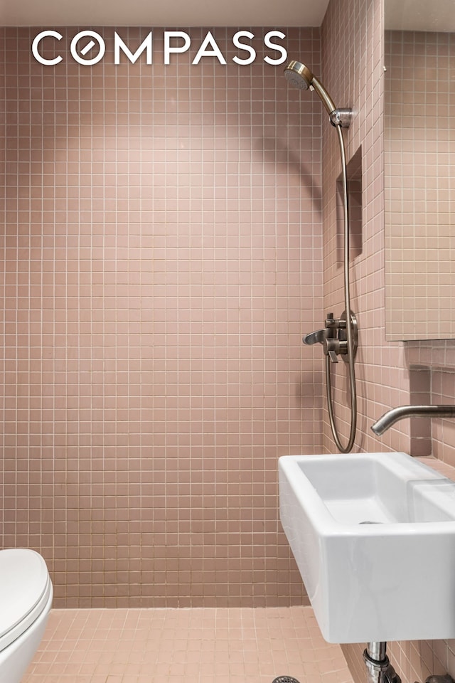 345 W 4th St Unit 8, New York City, NY 10014 - bathroom featuring tile walls, a sink, and toilet
