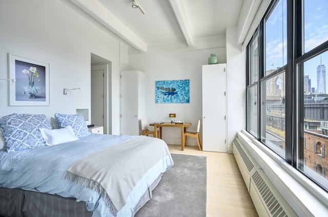 30 Main St Unit 7H, New York City, NY 11201 - bedroom with beamed ceiling, multiple windows, and wood finished floors