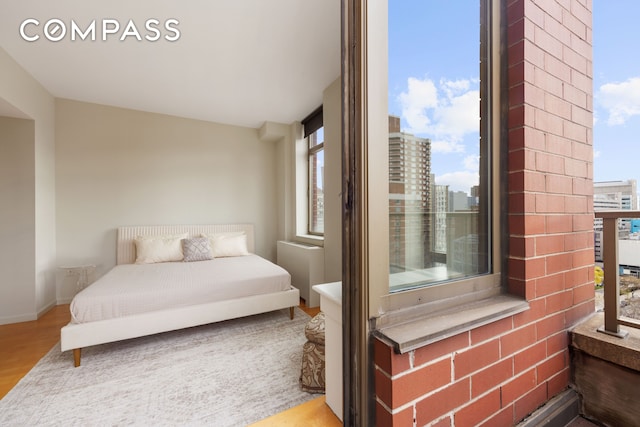 250 E 30th St Unit 14B, New York City, NY 10016 - bedroom featuring wood finished floors and baseboards