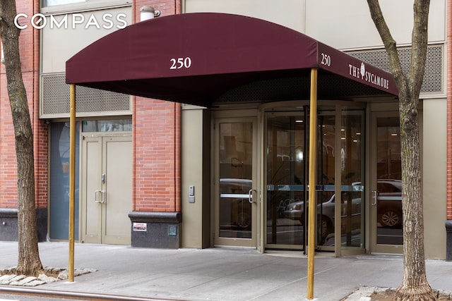 entrance to property featuring brick siding