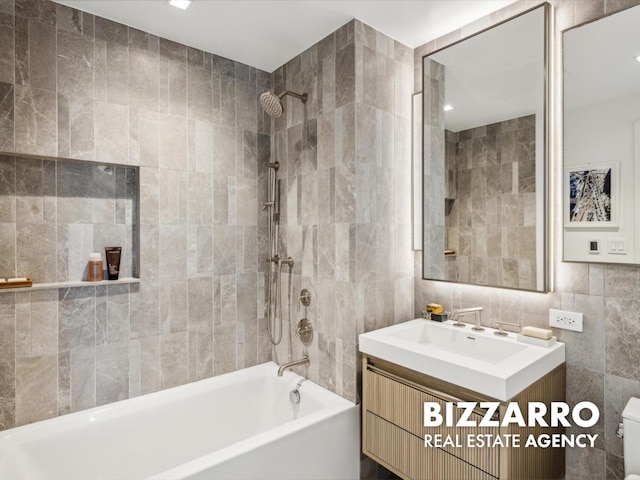 208 Delancey St Unit 8F, New York City, NY 10002 - full bath with tile walls, vanity, shower / bath combination, and toilet