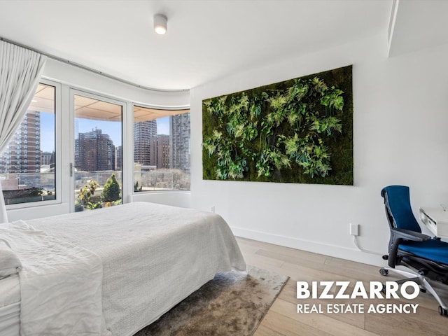 208 Delancey St Unit 8F, New York City, NY 10002 - bedroom with a city view, wood finished floors, and baseboards