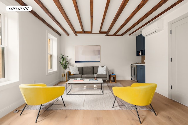 64 2nd St, New York City, NY 11231 - living area with a wall unit AC, light wood-style floors, and beam ceiling